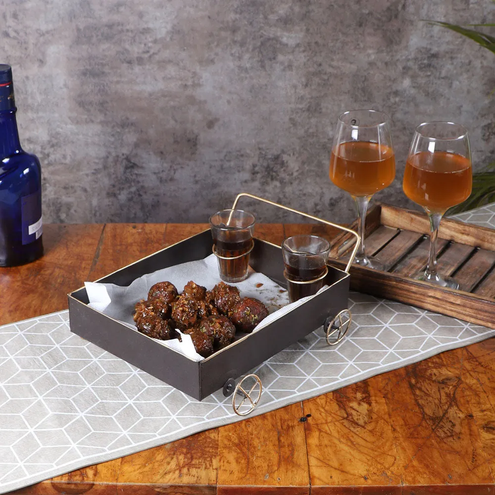 Classy Black Snacks Platter With Golden Wheels & Tea Glass